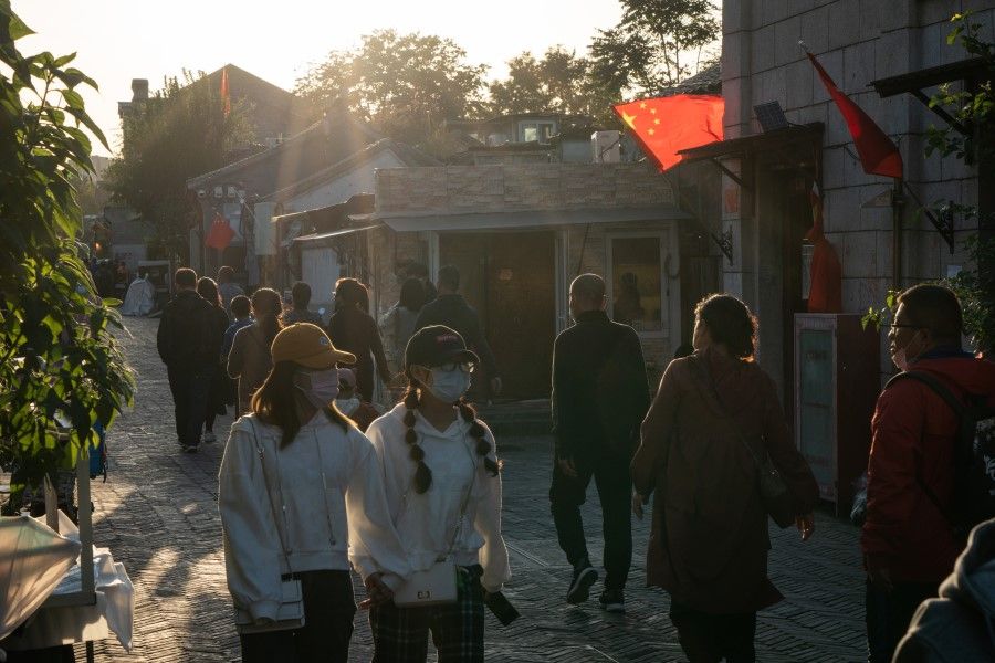 People walk in Qianmen area in Beijing, China, 4 October 2020. A significant rebound in domestic travel over the Golden Week holiday is fueling optimism that consumers are starting to spend again after the pandemic-induced slump. (Yan Cong/Bloomberg)