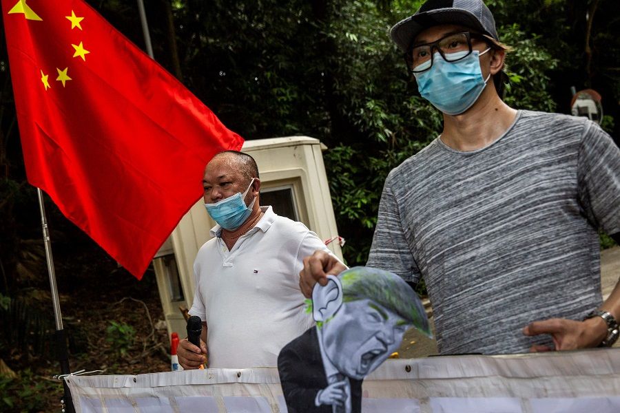 Protesters demonstrate outside the US consulate in Hong Kong on 8 August 2020, after the US imposed sanctions on Hong Kong Chief Executive Carrie Lam and other top officials in response to Beijing enacting a national security law on the city. (Photo by Isaac Lawrence/AFP)