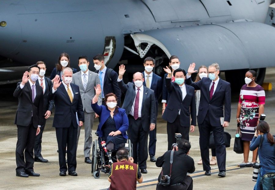US Senators Tammy Duckworth, Dan Sullivan, and Chris Coons wave next to Taiwan Foreign Minister Joseph Wu and Brent Christensen, director of the American Institute in Taiwan, after their arrival via a US Air Force freighter at Taipei Songshan Airport in Taipei on 6 June 2021. (Central News Agency/Pool via Reuters)
