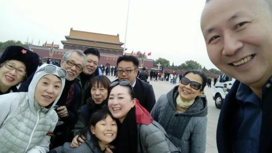 Saito and his family at his Beijing exhibition; photo together at Tiananmen Square, 2019.