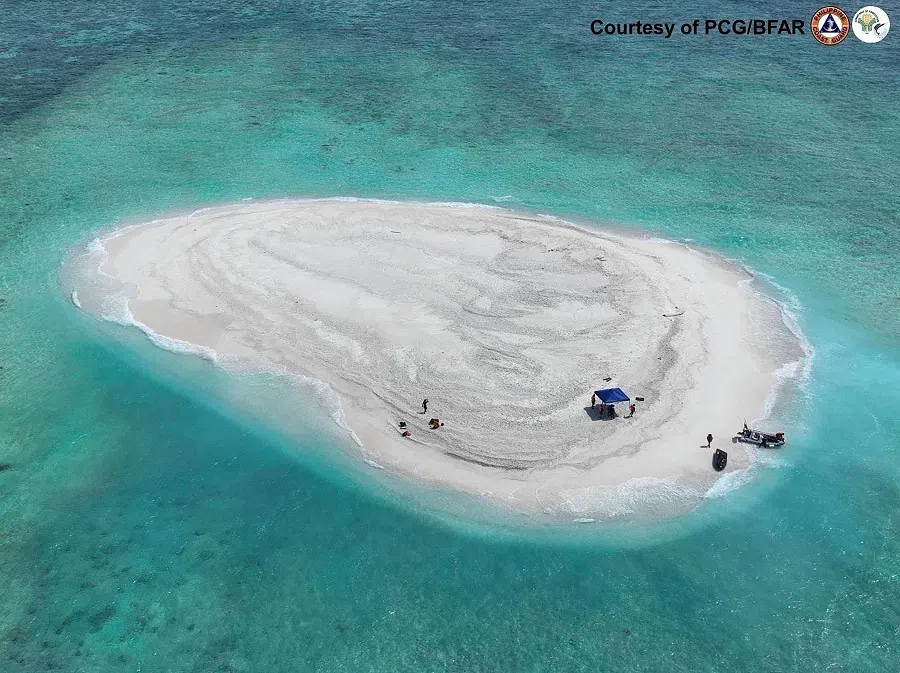 This handout photo taken on 21 March 2024 and received from the Philippine Coast Guard and Bureau of Fisheries and Aquatic Resources (PCG/BFAR) shows an aerial view of Philippine scientists inspecting Sandy Cay reef, near the Philippine-held Thitu Island, in Spratly Islands, in disputed waters of the South China Sea. The Chinese coast guard seized control of a disputed reef near a major Philippine military outpost in the South China Sea, according to Beijing’s state media, adding to longstanding territorial tensions with Manila.