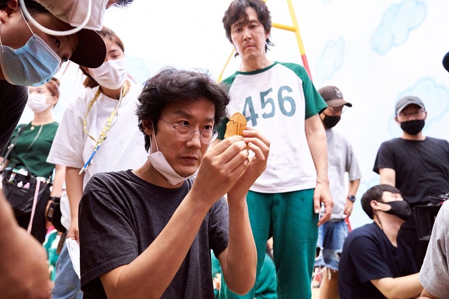 Writer-director Hwang Dong-hyuk (left) and Lee Jung-jae on the set of Squid Game. (Netflix)