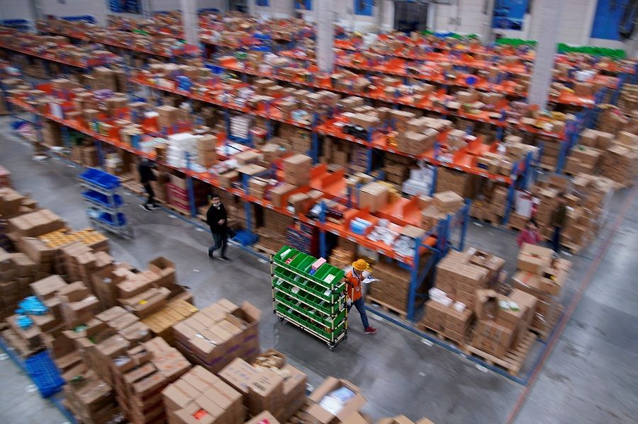 Employees work at a warehouse of Cainiao, Alibaba's logistics unit, in Wuxi, Jiangsu province, China, on 26 October 2020. (Aly Song/Reuters)