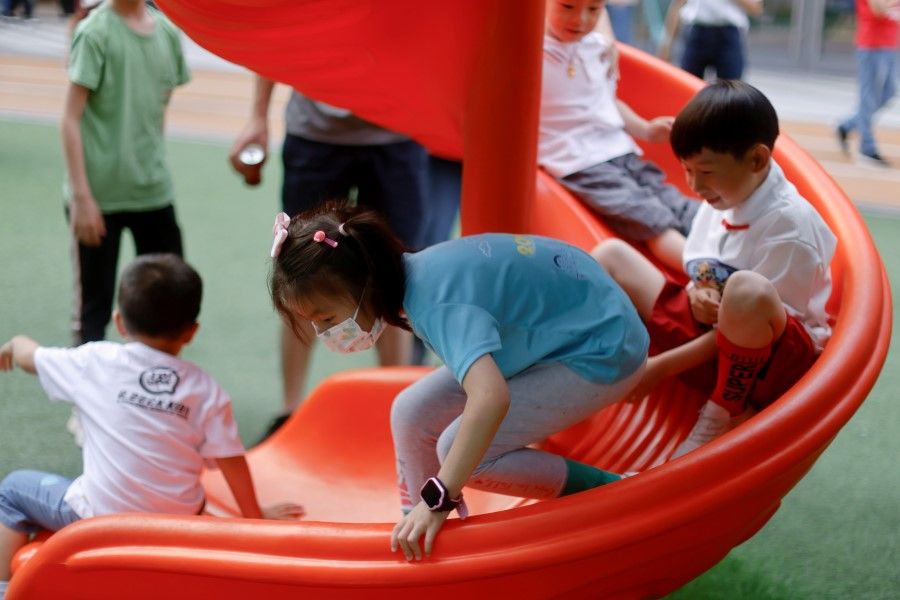 Children play at a playground inside a shopping complex in Shanghai, China, 1 June 2021. (Aly Song/Reuters)