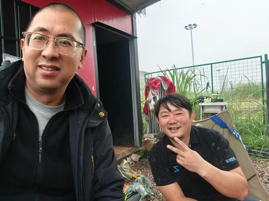 Tang Zisong (left), a long-time merchant and motorcycle instructor from Laodingpo, poses for a photo with Zhang Xue in Chongqing in 2025. (Photo provided by interviewee)