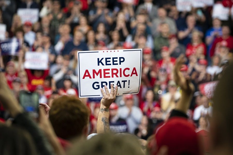 An attendee holds a sign that reads 'Keep America Great!' during a rally for US President Donald Trump in Des Moines, Iowa, on 30 January 2020. (Al Drago/Bloomberg)
