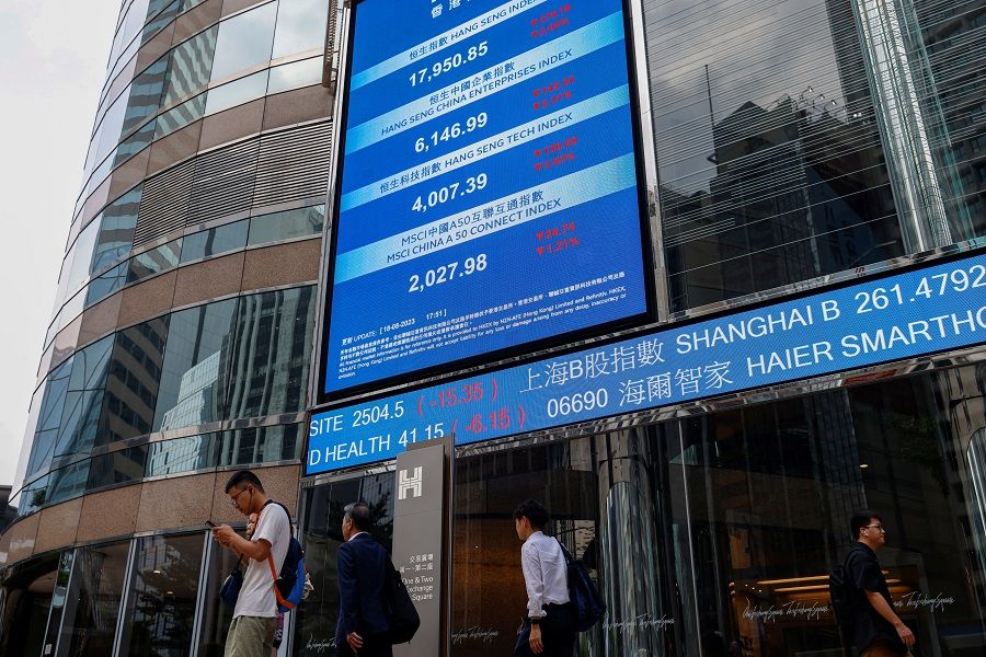 Screens showing the Hang Seng stock index and stock prices are seen outside Exchange Square, in Hong Kong, China, on 18 August 2023. (Tyrone Siu/Reuters)