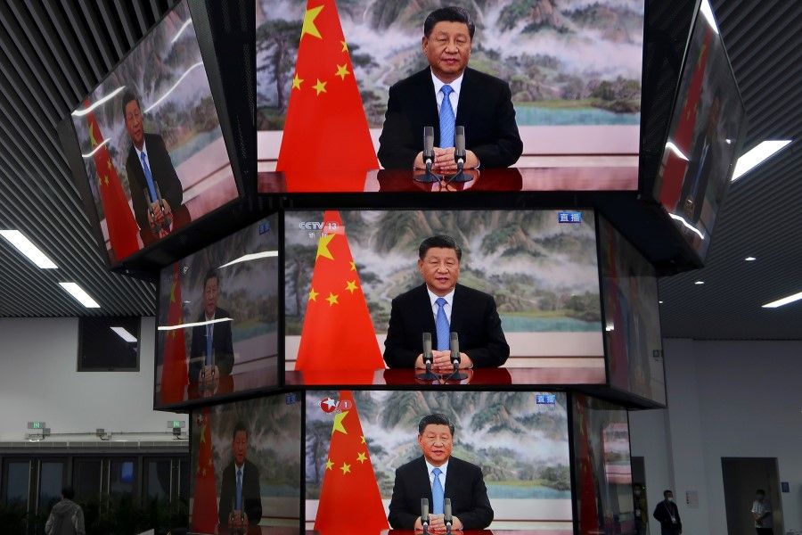 Chinese President Xi Jinping is seen on television screens at a media centre as he delivers a speech via video at the opening ceremony of the China International Import Expo (CIIE) in Shanghai, China, 4 November 2021. (Andrew Galbraith/Reuters)