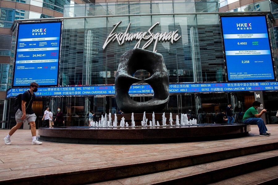 Digital signs display stock market information in the Central district of Hong Kong on 5 November 2021. (Isaac Lawrence/AFP)