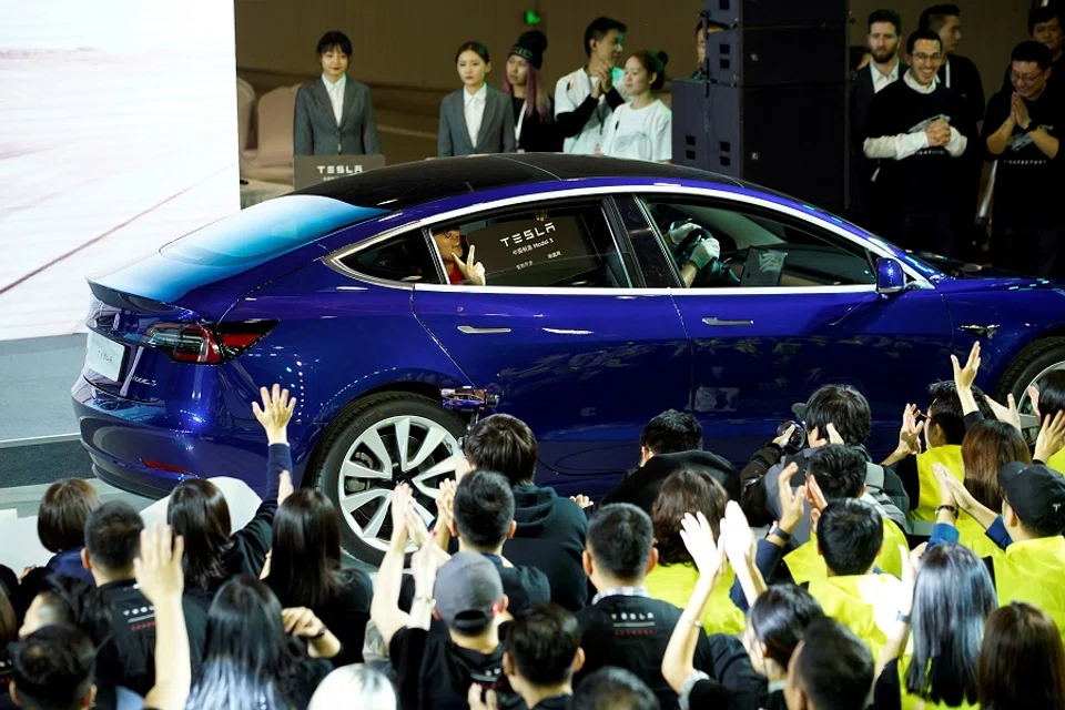 A Tesla China-made Model 3 vehicle owner sits inside a car during a delivery event at Tesla's Shanghai factory in China, 7 January 2020. (Aly Song/File Photo/Reuters)