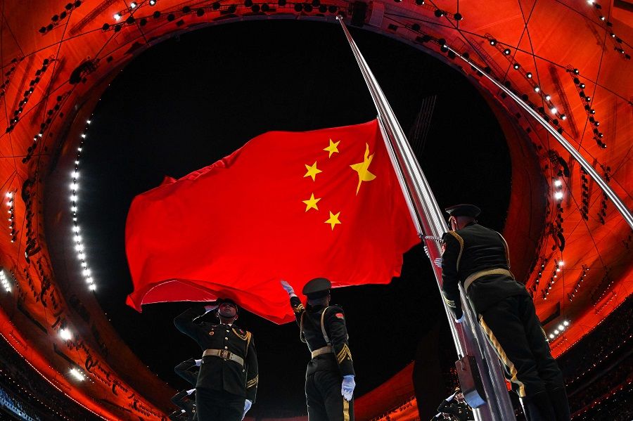 The Chinese national flag is raised during the opening ceremony of the Beijing 2022 Winter Olympic Games, at the National Stadium, also known as the Bird's Nest, in Beijing, China, on 4 February 2022. (Lillian Suwanrumpha/AFP)