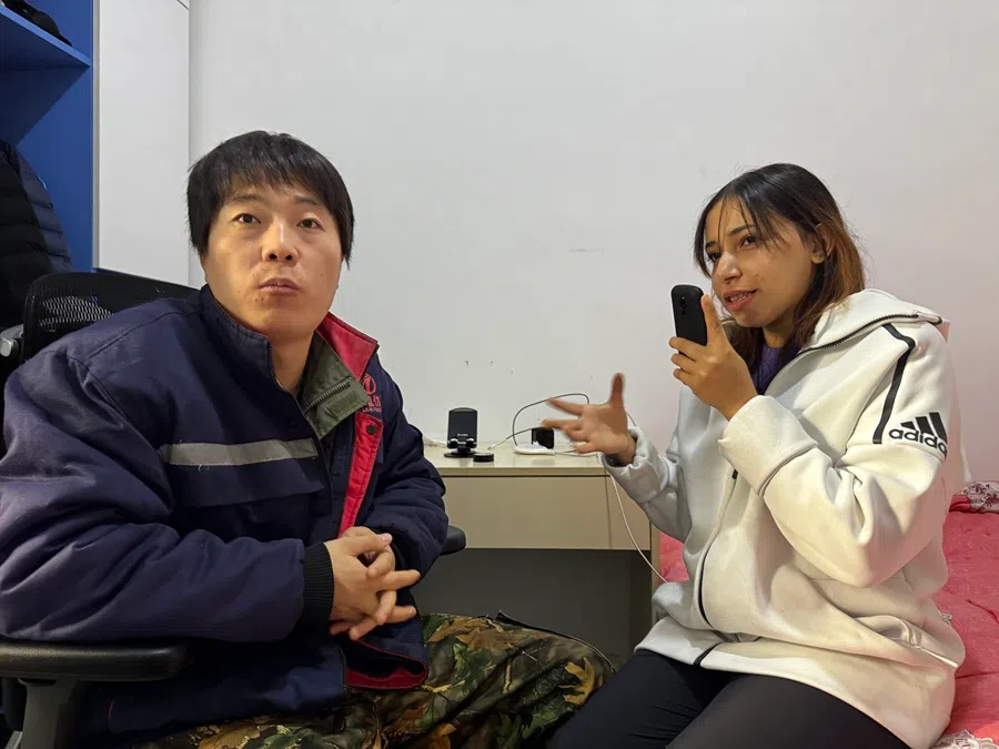 Wang communicates with Mennatalla via a translation app. (Sim Tze Wei/SPH Media)