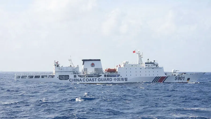 This handout photo taken on 11 January 2025 and released on 12 January by the Philippine Coast Guard (PCG) shows a Chinese Coast Guard ship sailing some 60 nautical miles (111 kilometres, 69 miles) west of the main Philippine island of Luzon while being monitored by Philipine Coast Guard ship BRP Teresa Magbanua (not pictured).