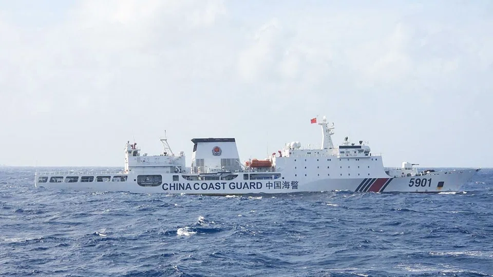 This handout photo taken on 11 January 2025 and released on 12 January by the Philippine Coast Guard (PCG) shows a Chinese Coast Guard ship sailing some 60 nautical miles (111 kilometres, 69 miles) west of the main Philippine island of Luzon while being monitored by Philipine Coast Guard ship BRP Teresa Magbanua (not pictured). (Handout/Philippine Coast Guard (PCG)/AFP)