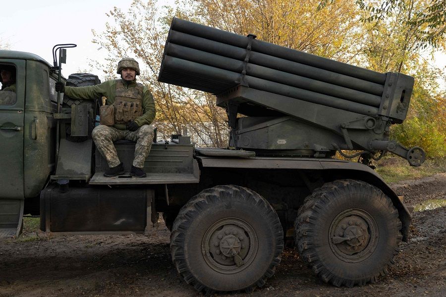 A Ukrainian soldier sits on a vehicle with multiple rocket launchers outside Mykolaiv, Ukraine, on 2 November 2022, amid the Russian invasion of Ukraine. (Bulent Kilic/AFP)