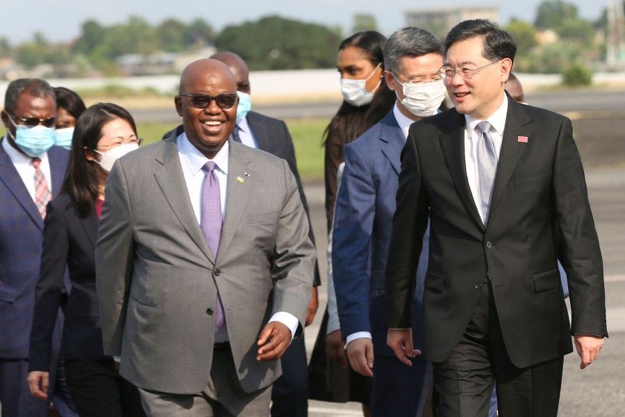 China's Minister of Foreign Affairs Qin Gang (right) is greeted by Gabon's Minister of Foreign Affairs Michael Moussa Adamo (left) upon his arrival at the Leon Mba International Airport in Libreville on 11 January 2023. (Steeve Jordan/AFP)