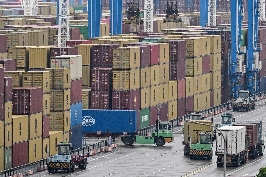 Trucks drive past containers at the Port of Ningbo-Zhoushan in Ningbo, in China’s eastern Zhejiang province on 28 May 2025. (Hector Retamal/AFP)