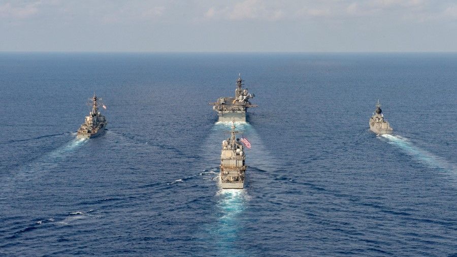 Royal Australian Navy helicopter frigate HMAS Parramatta (top R) conducts officer of the watch manoeuvres in the South China Sea with amphibious assault ship USS America (top C), guided-missile destroyer USS Barry (top L) and guided-missile cruiser USS Bunker Hill (C), in this 18 April, 2020 handout photo. (Australia Department Of Defence/Handout via REUTERS)