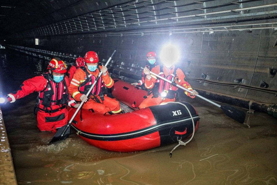 This photo taken on 26 July 2021 shows rescuers searching inside the subway which was flooded following heavy rains in Zhengzhou, in China's central Henan province. (STR/AFP)
