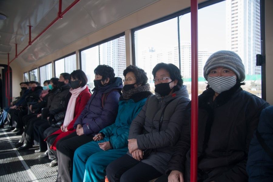 Commuters wearing face masks ride a tramcar in Pyongyang on February 26, 2020. (Kim Won-Jin/AFP)