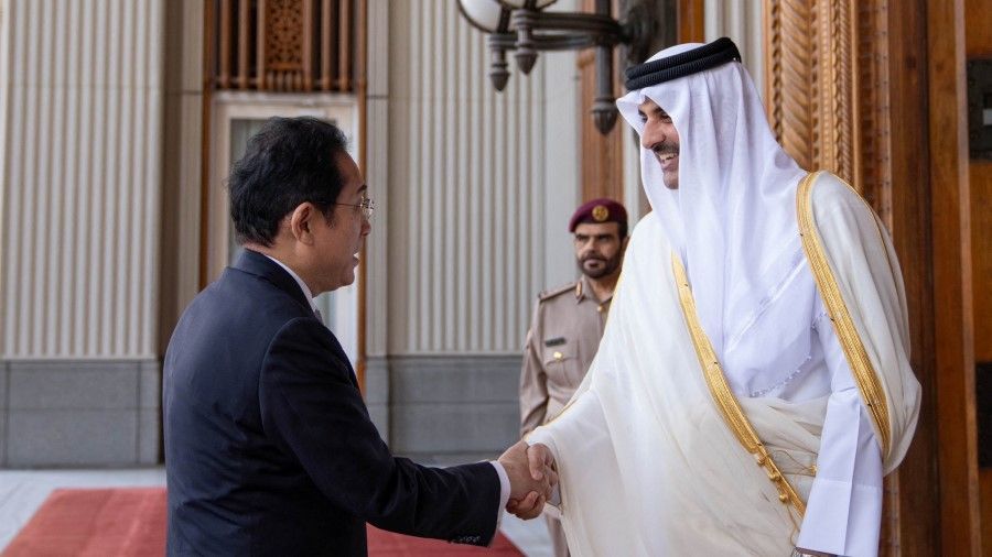 Qatar's Emir Sheikh Tamim Bin Hamad Al-Thani shakes hands with Japan's Prime Minister Fumio Kishida at the Amiri Diwan in Doha, Qatar, 18 July 2023. (Amiri Diwan/Handout via Reuters)