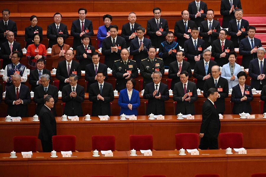 Chinese President Xi Jinping (front, right) and Premier Li Qiang (front, left) arrive for the opening session of the National People's Congress (NPC) at the Great Hall of the People in Beijing, China, on 5 March 2024. (Pedro Pardo/AFP)
