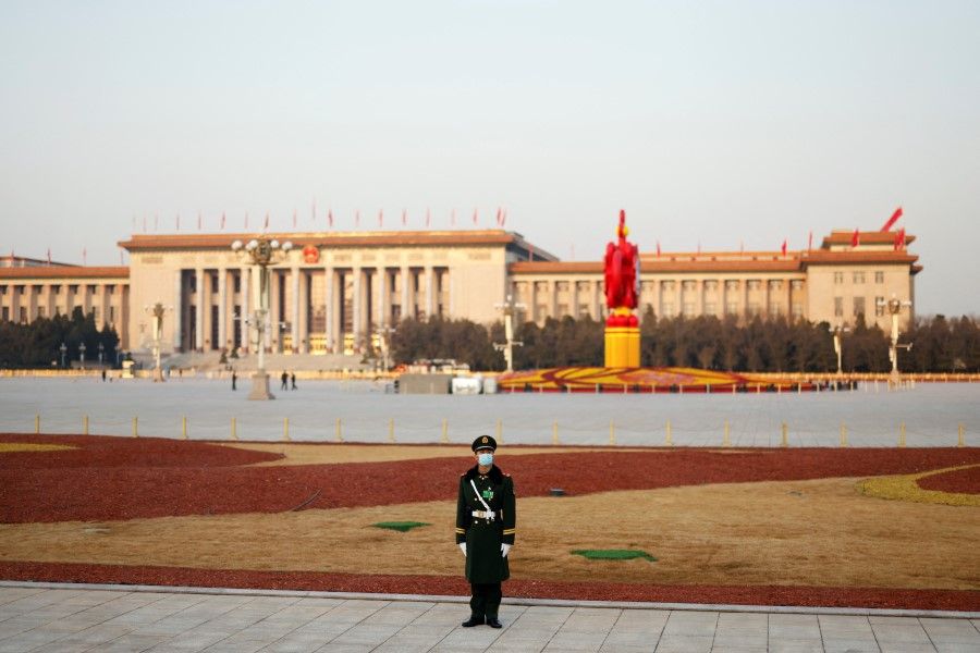 A paramilitary police officer stands guard on the Tiananmen Square, in front of the Great Hall of the People in Beijing, China, 8 March 2022. (Carlos Garcia Rawlins/Reuters)