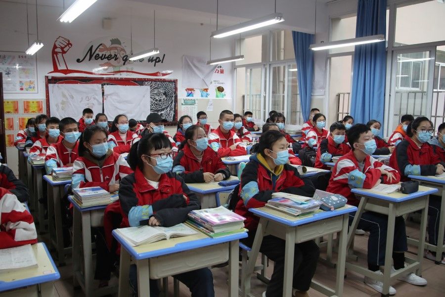 Junior high students wearing face masks attend a class in Guiyang, Guizhou province, China, 16 March 2020. (cnsphoto via Reuters)