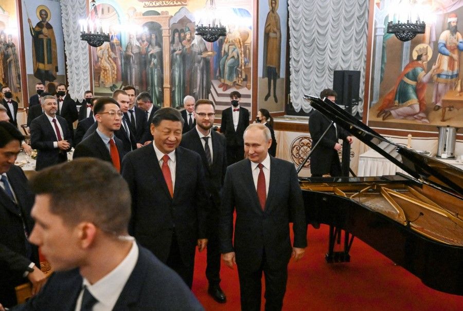 Russian President Vladimir Putin and Chinese President Xi Jinping attend a reception in honour of the Chinese leader's visit to Moscow, at the Kremlin in Moscow, Russia, on 21 March 2023. (Grigory Sysoev/Kremlin/Sputnik via Reuters)