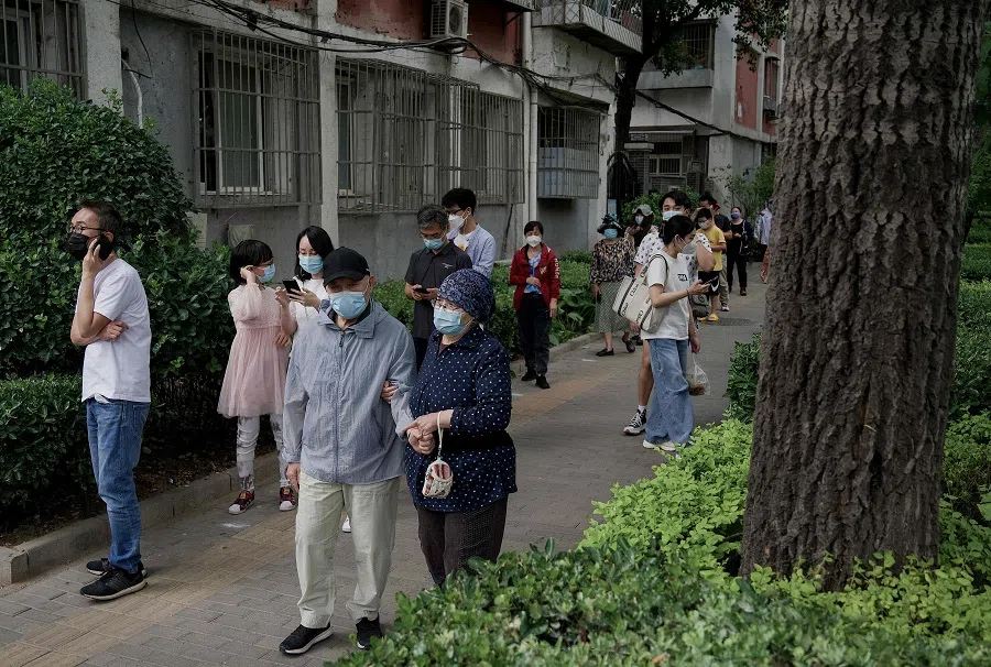 People queue to be tested for Covid-19 in Beijing, China, on 17 May 2022. (Noel Celis/AFP)