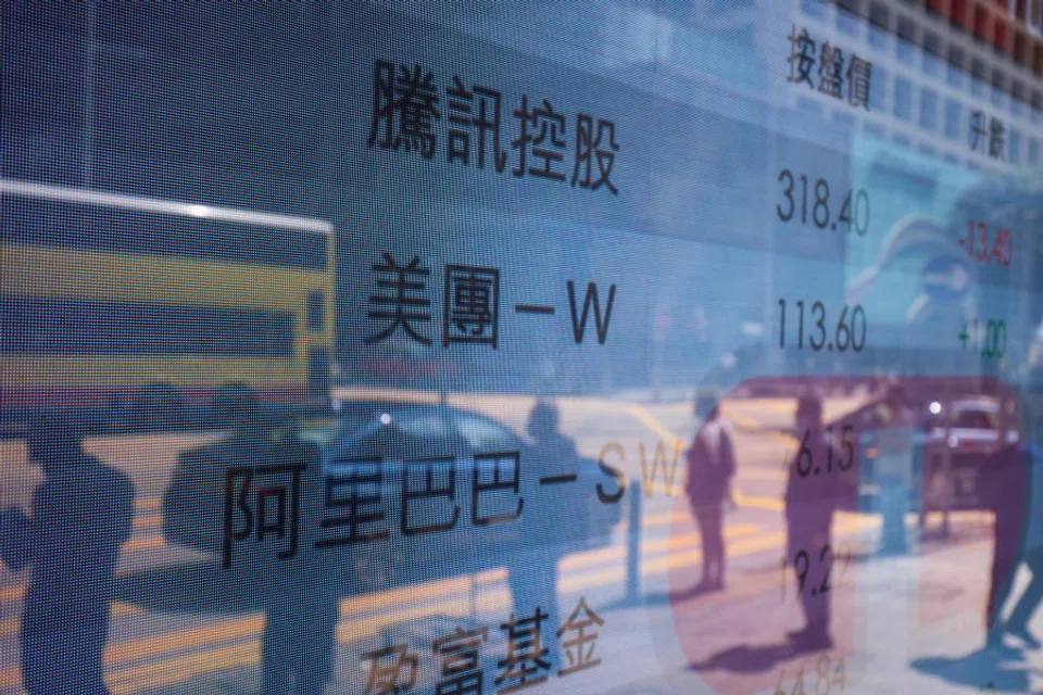 An electronic screen displays the stock figures for companies including Tencent Holdings Ltd., Meituan and Alibaba Group Holding Ltd. in Hong Kong, China, on 15 March 2022. (Paul Yeung/Bloomberg)