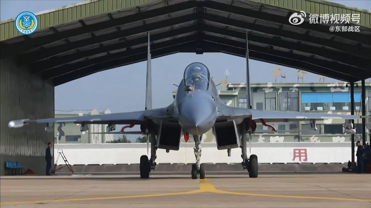This screenshot of undated video footage released on 23 May 2024 on Chinese social media platform Weibo by China’s People’s Liberation Army (PLA) shows a Chinese fighter jet in an unknown location.  (Handout/China’s People’s Liberation Army/AFP)