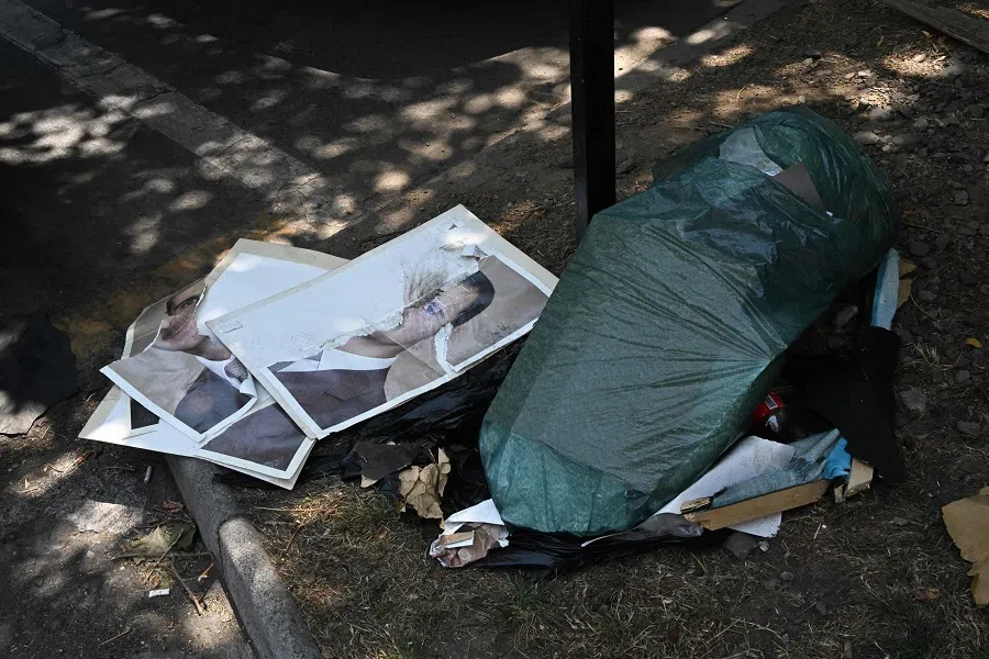 Destroyed pictures of ousted Syrian President Bashar al-Assad lie on the floor of the Syrian embassy as Syrian citizens living in Chile celebrate his fall in Santiago on 10 December 2024. (Rodrigo Arangua/AFP)
