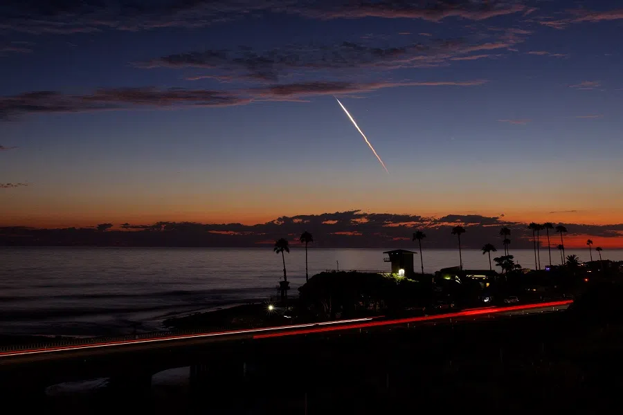 An evening launch of a SpaceX Falcon 9 rocket carrying 20 Starlink V2 Mini satellites, from Space Launch Complex at Vandenberg Space Force Base, is seen over the Pacific Ocean from Encinitas, California, US, 23 June 2024. (Mike Blake/Reuters)