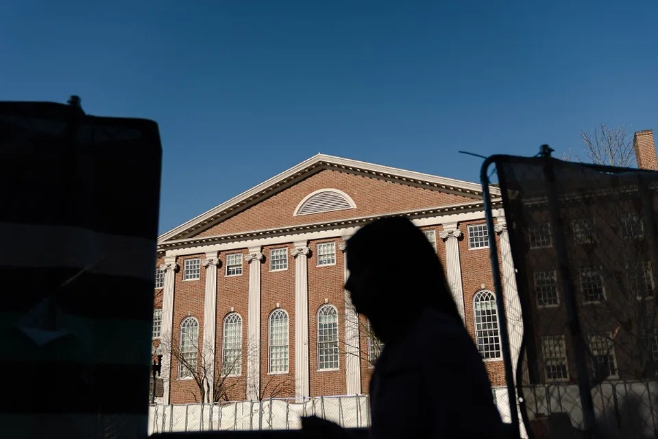 People walk past Harvard University in Harvard Square on 17 April 2025 in Cambridge, Massachusetts, US. (Sophie Park/Getty Images/AFP)