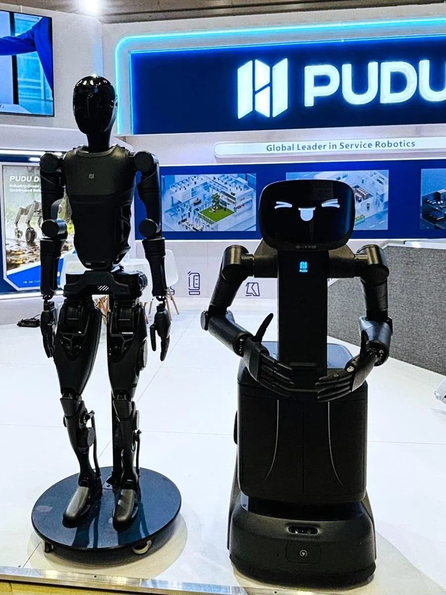 Pudu Robotics’s humanoid robot PUDU D9 and semi-humanoid robot FlashBot Arm seen at the International Robot Exhibition 2025, Tokyo, Japan, December 2025. (SPH Media)