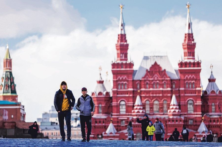 People walk at the Red Square in Moscow, Russia, 30 March 2022. (Maxim Shemetov/Reuters)