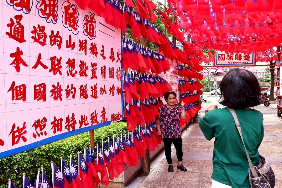 People take photos at a square decorated with Taiwan flags ahead of the Double Tenth Day celebration in Taoyuan, Taiwan, 8 October 2021. (Ann Wang/Reuters)