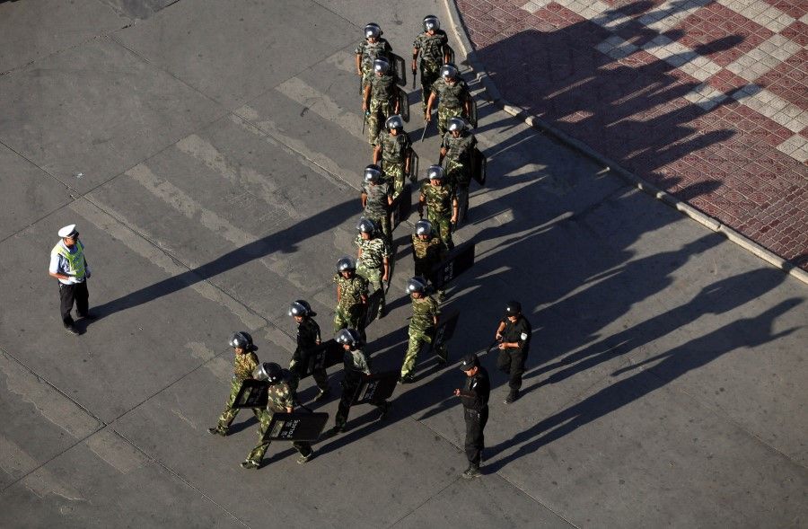 Armed police officers are deployed at a square in Kashgar, Xinjiang, 2 August 2011. (Stringer/Reuters)