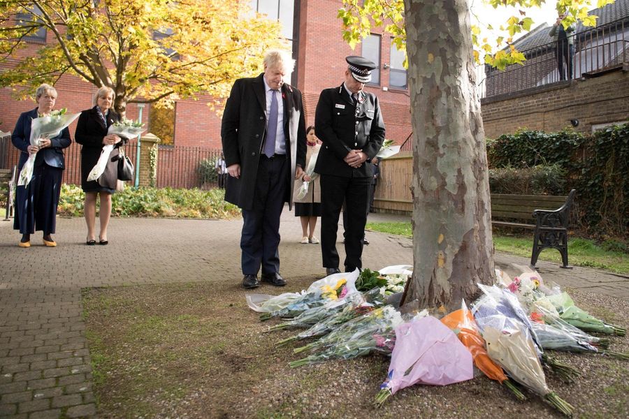 Britain's Prime Minister Boris Johnson stands with Chief Constable of Essex Police, Ben-Julian Harrington (right), after they laid flowers, during a visit to Thurrock Council Offices in Thurrock, east of London on October 28, 2019, following the October 23, 2019, discovery of 39 bodies concealed in a lorry. (Stefan Rousseau/POOL/AFP)