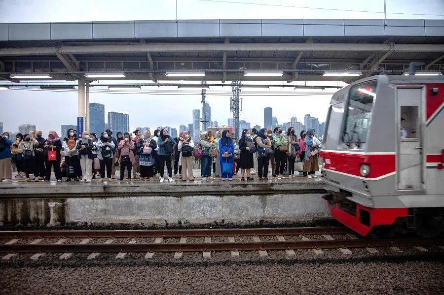 People wait for a train on the platform at Sudirman Station in Jakarta, Indonesia, on 18 February 2025.  (Aditya Irawan/AFP)