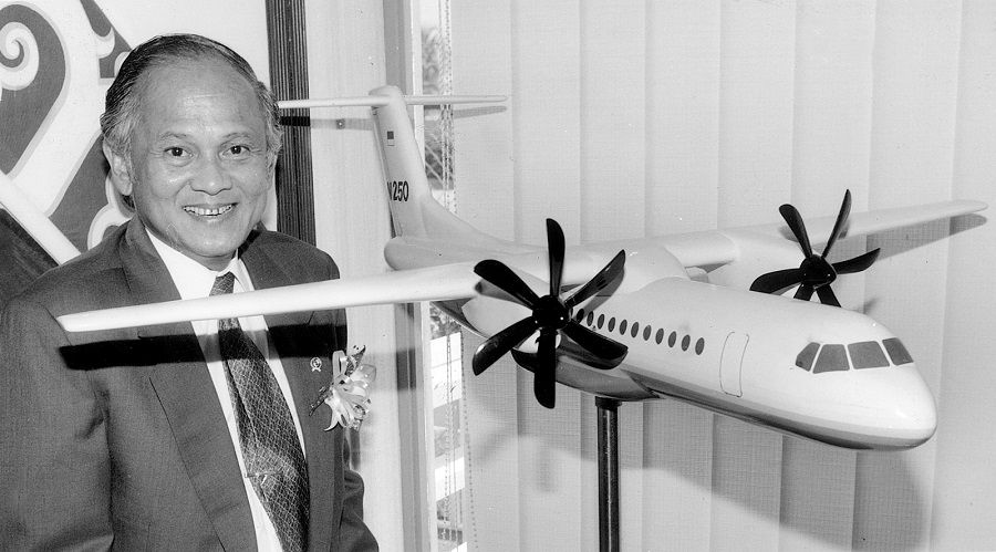 Former Indonesian President B. J. Habibie stands next to a model of N-250, the first Indonesia-designed plane. (SPH Media)