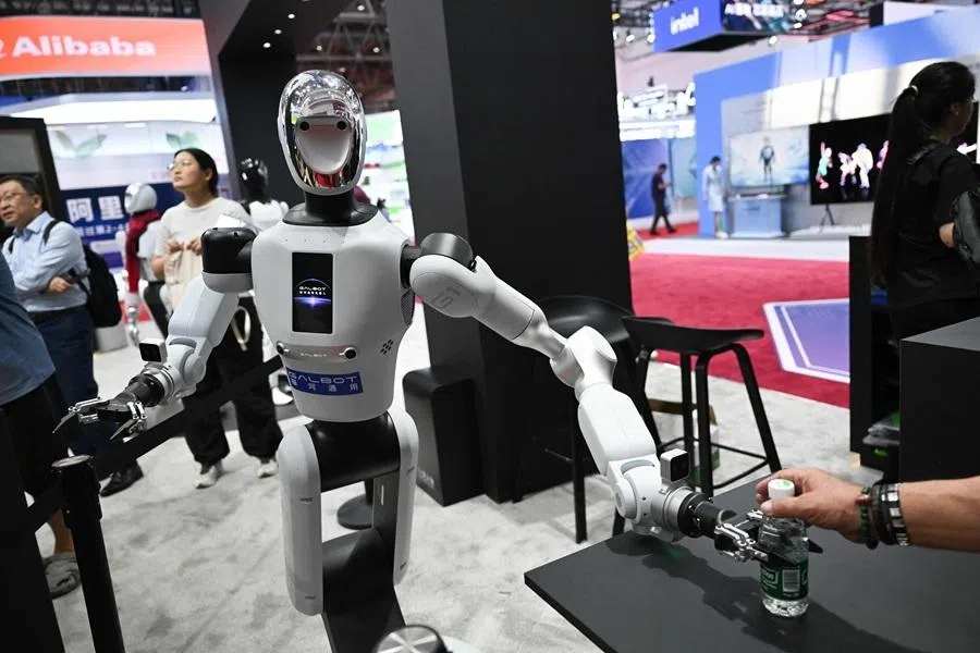 A Galbot humanoid robot serves a bottle of water at the NVIDIA booth during the China International Supply Chain Expo (CISCE) in Beijing on 25 June 2026.