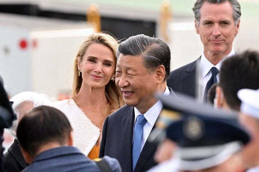 California governor Gavin Newsom (right) and his partner Jennifer Siebel Newsom (left) look on as Chinese President Xi Jinping (center) arrives at San Francisco International airport, as to attend the Asia-Pacific Economic Cooperation (APEC) leaders' week in San Francisco, California, on 14 November 2023. (Frederic J. Brown/AFP)