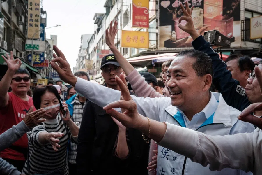 Hou Yu-ih (centre), presidential candidate of the main opposition Kuomintang (KMT), greets supporters during his campaign rally with local legislative candidates at the Sanhe Market in Kaohsiung on 10 January 2024. (Yasuyoshi Chiba/AFP)