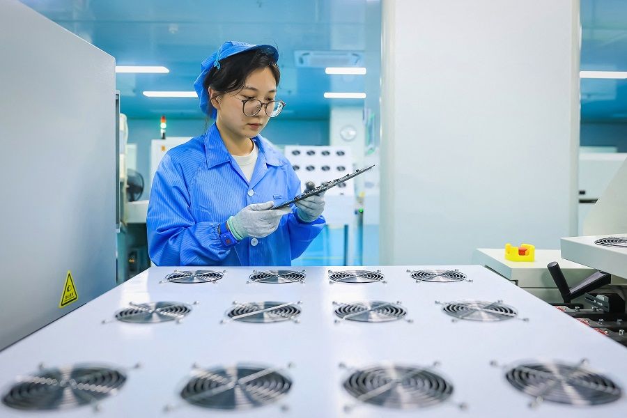 An employee produces components for a new energy vehicle at a factory in Ruichang, in southeastern China's Jiangxi province on 19 September 2023. (AFP)