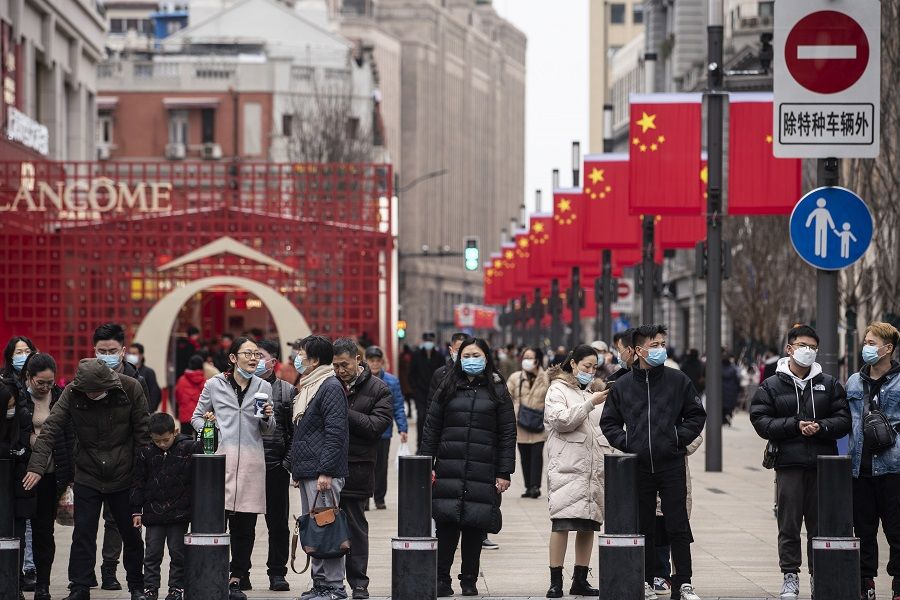 Pedestrians walk down Nanjing Road in Shanghai, China, on 12 February 2021. (Qilai Shen/Bloomberg)