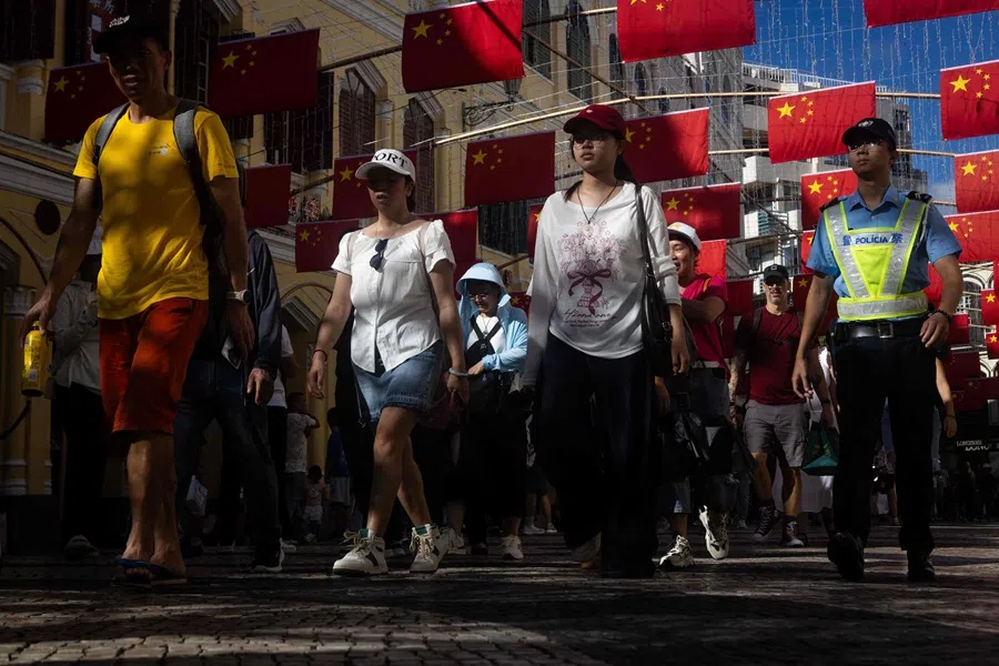 Visitors walk at Senado Square during China's golden week holiday in Macau on  2 October 2025. (Eduardo Leal/AFP)