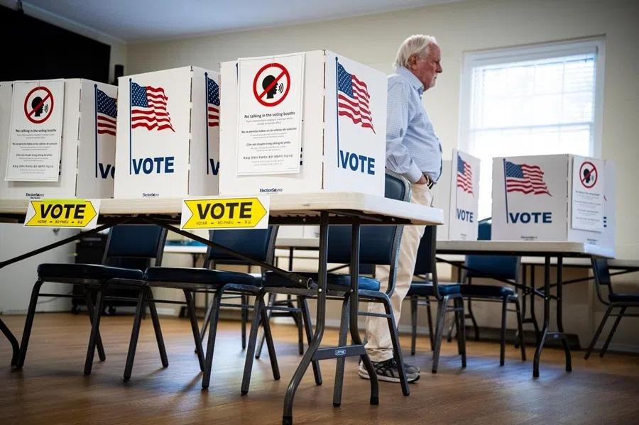 An election official stands among voting booths at a polling location inside Great Falls United Methodist Church during a primary election in Great Falls, Virginia, US, on 4 August 2026.