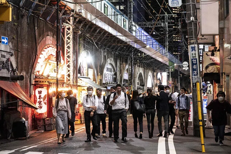 People walk along a street in Tokyo, Japan, on 30 September 2021. (Charly Triballeau/AFP)